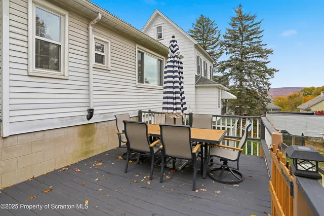 a view of a chairs and table on the deck with wooden floor