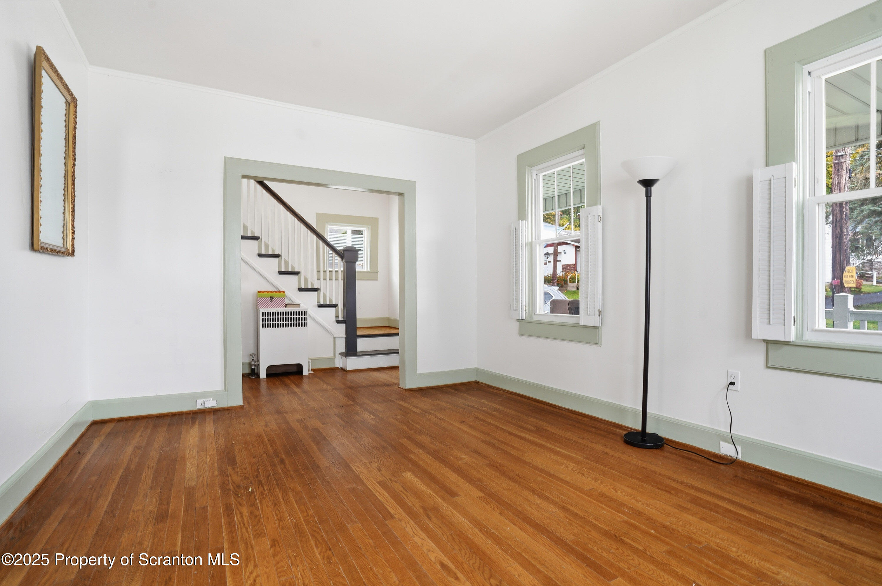123 William Street Scranton, PA 18510 - Photo 7 of 25 a view of an empty room with wooden floor and a window