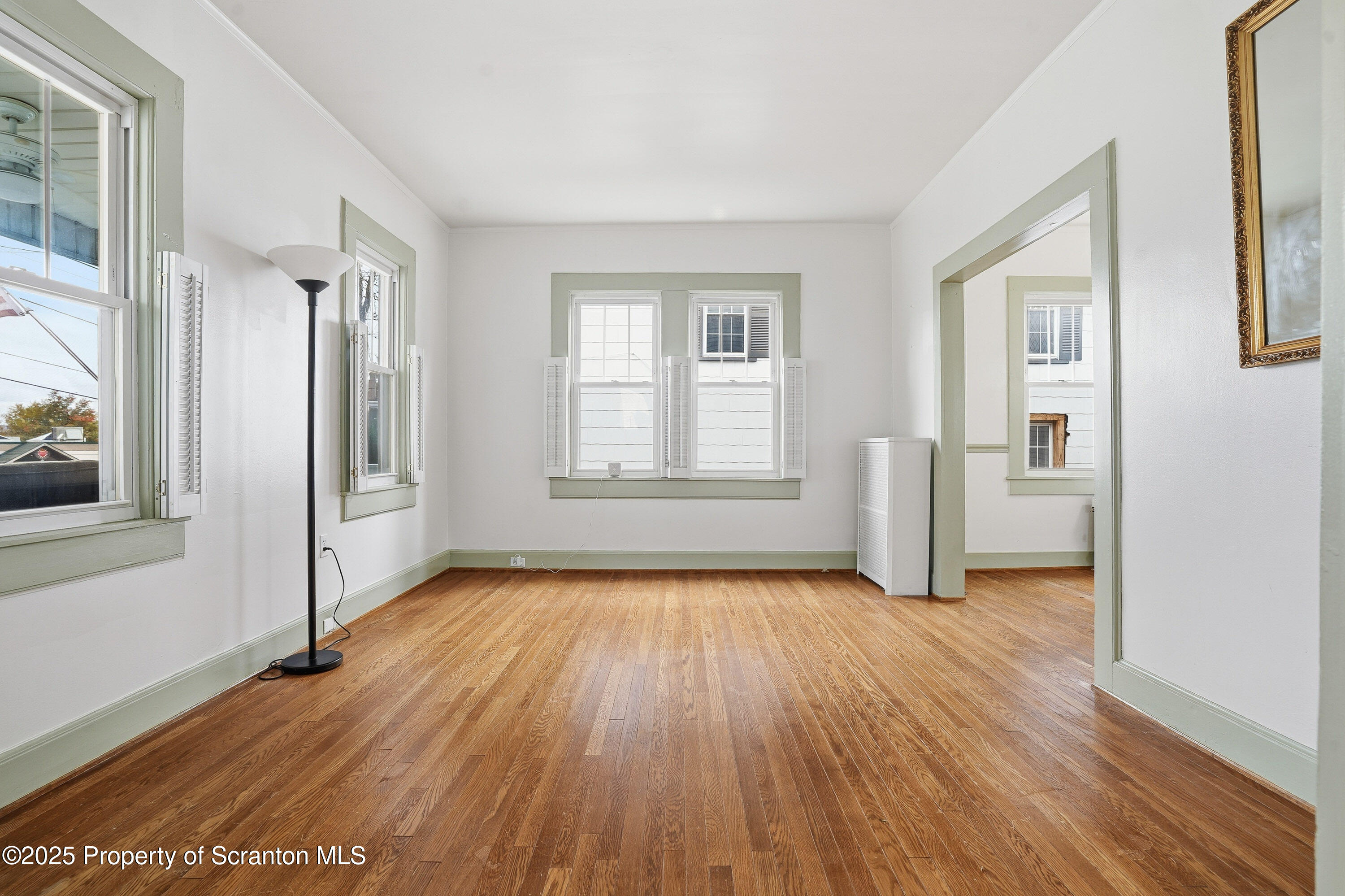 123 William Street Scranton, PA 18510 - Photo 8 of 25 an empty room with wooden floor and windows