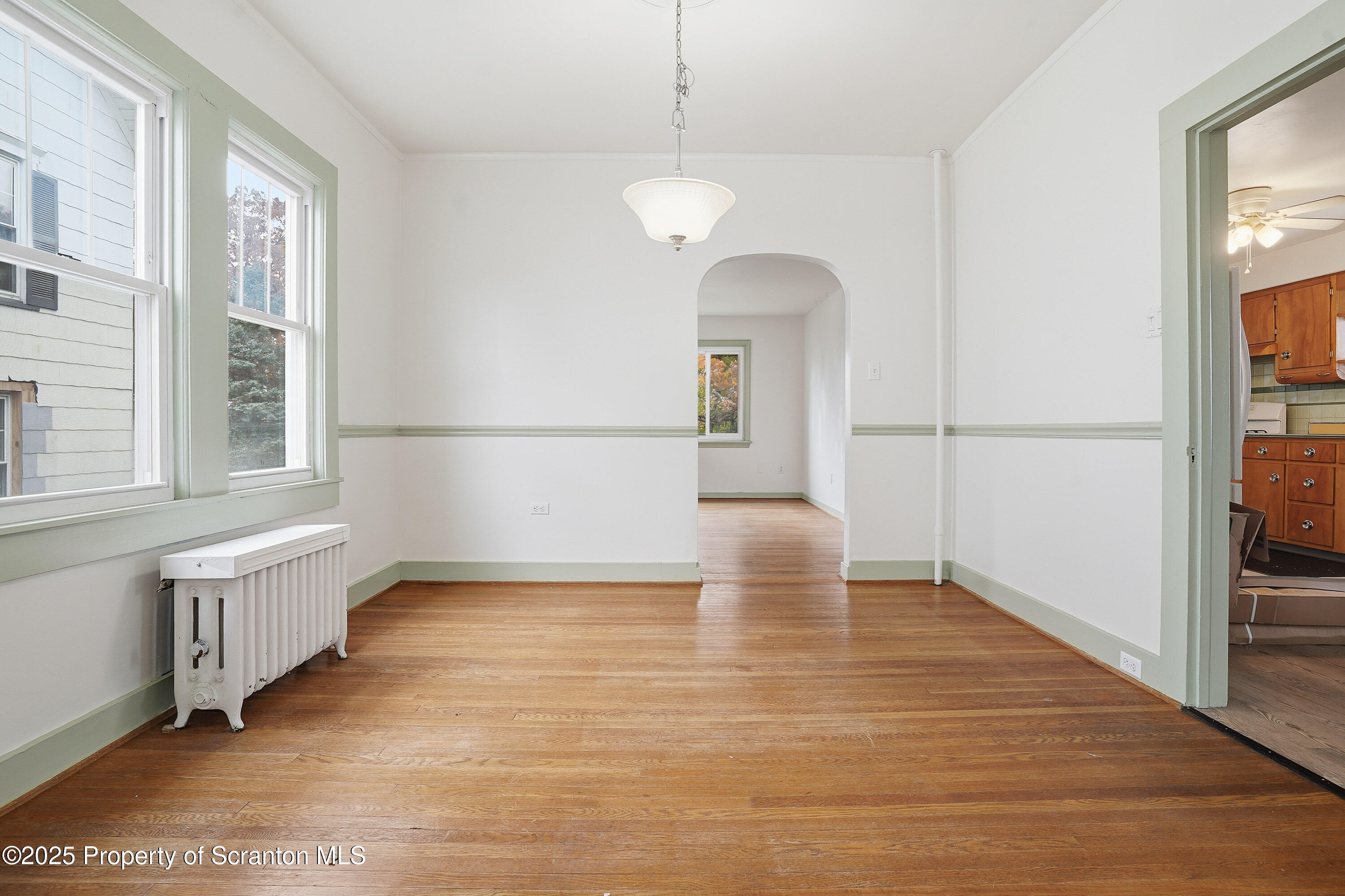 123 William Street Scranton, PA 18510 - Photo 9 of 25 a view of empty room with wooden floor and fan