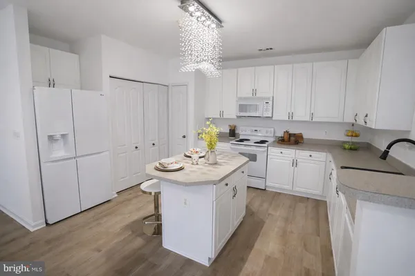 a kitchen with a sink a stove and cabinets