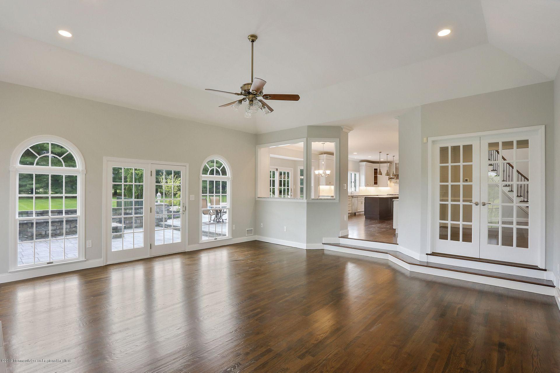 7 Pheasant Road Colts Neck, NJ 07722 - Photo 14 of 50 a view of an empty room with wooden floor and a window