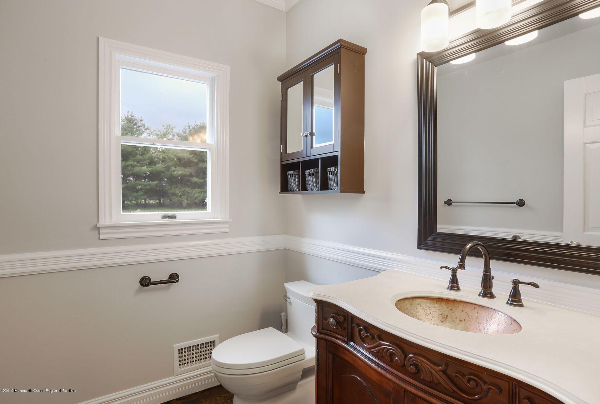 7 Pheasant Road Colts Neck, NJ 07722 - Photo 22 of 50 a bathroom with a granite countertop toilet a sink and a mirror