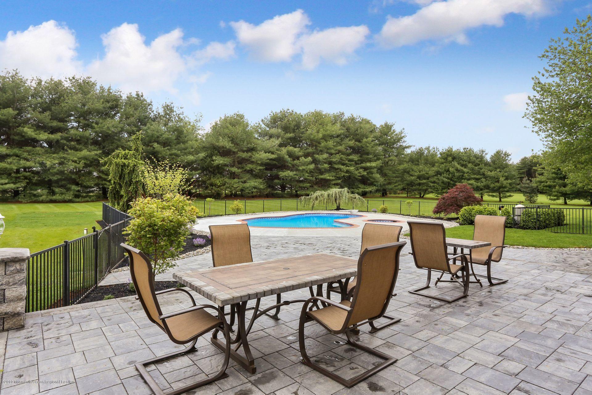 7 Pheasant Road Colts Neck, NJ 07722 - Photo 40 of 50 a view of a chairs and table on the terrace
