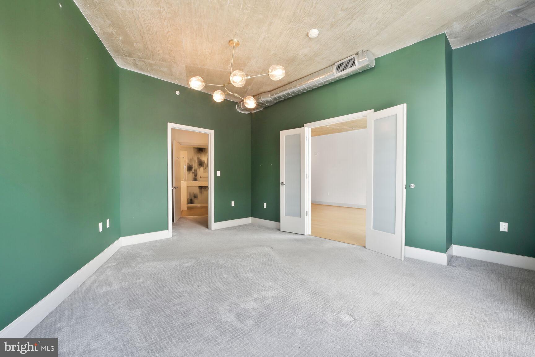 929 Florida Avenue Northwest, Unit 4008 Washington, DC 20001 - Photo 13 of 33 an empty room with a chandelier and a chandelier fan