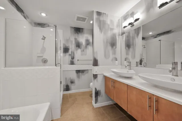 a bathroom with a double vanity sink mirror double and shower