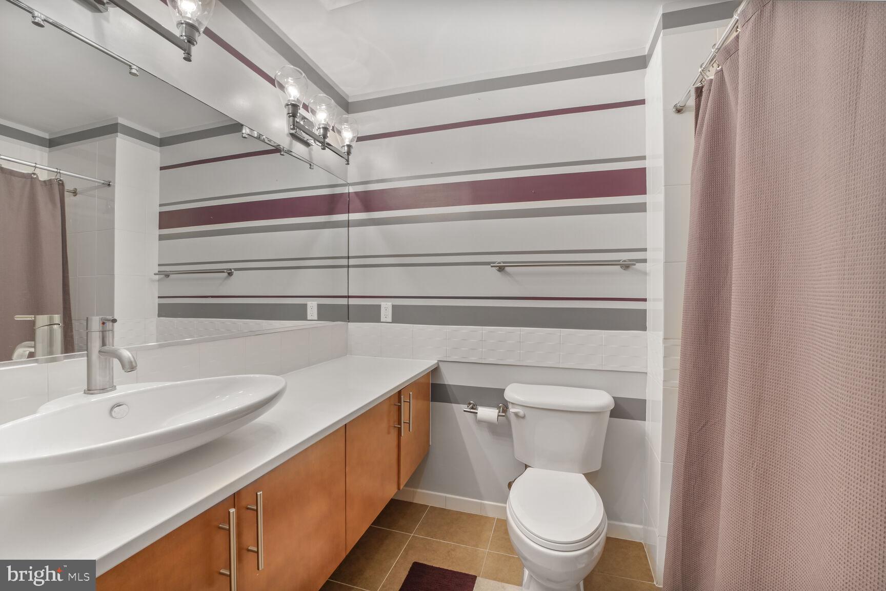 929 Florida Avenue Northwest, Unit 4008 Washington, DC 20001 - Photo 20 of 33 a bathroom with a sink a toilet and a mirror