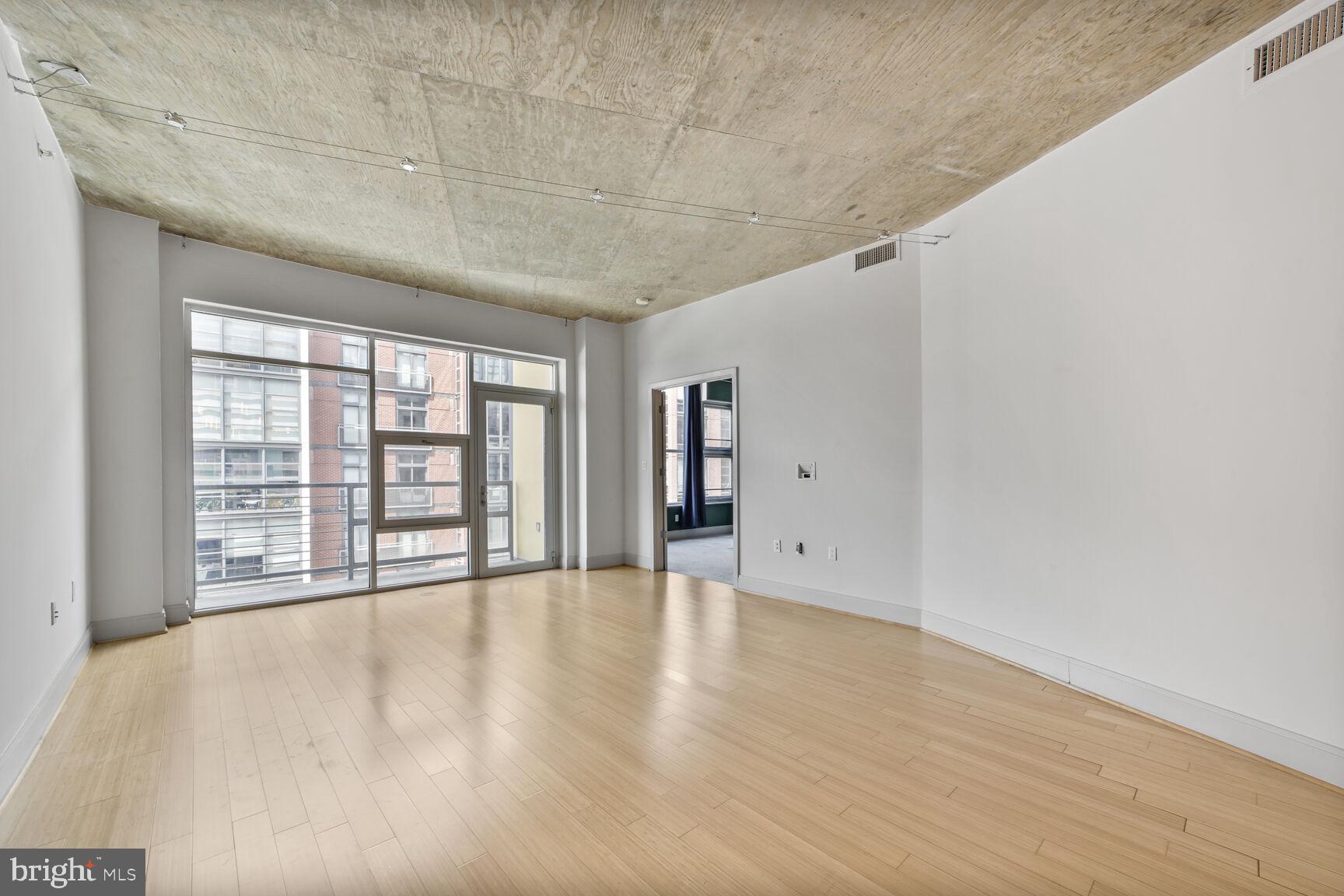 929 Florida Avenue Northwest, Unit 4008 Washington, DC 20001 - Photo 2 of 33 wooden floor in an empty room with a window