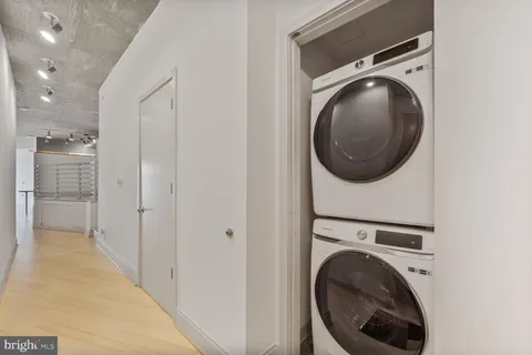 a view of a hallway with washer and dryer