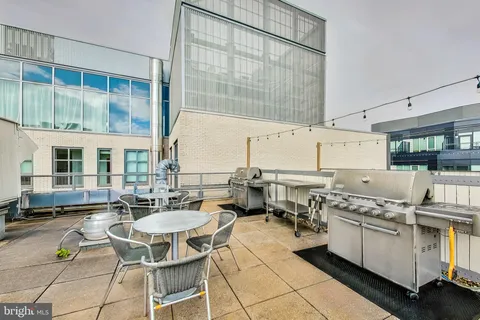 a open kitchen with a table chairs and white cabinets