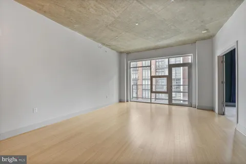 wooden floor in an empty room with a window