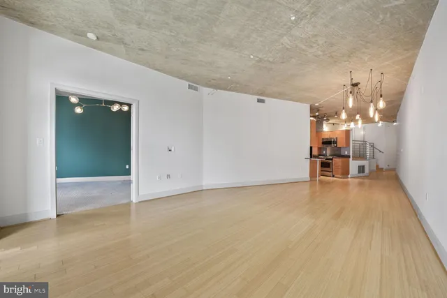 a view of a room with wooden floor
