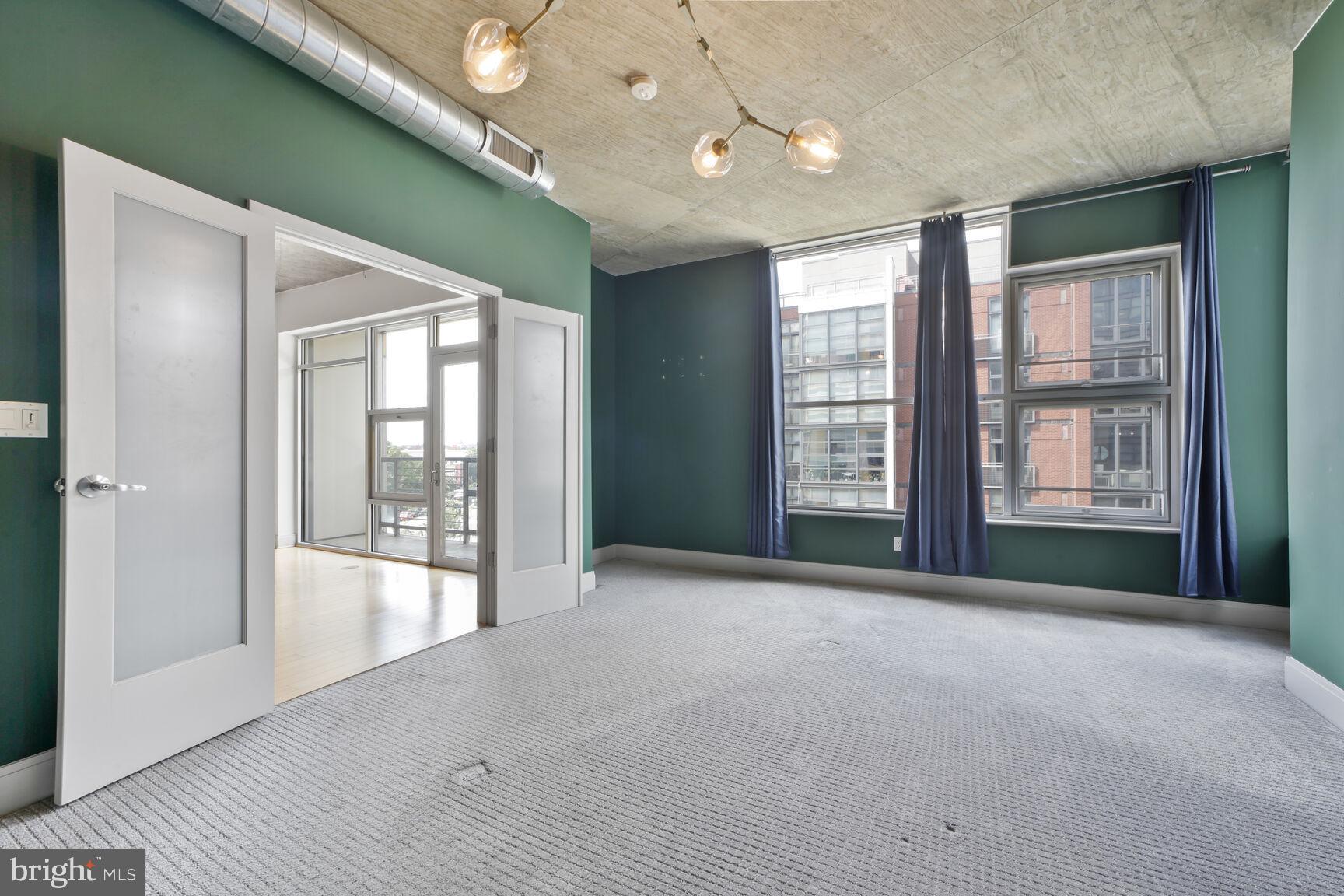 929 Florida Avenue Northwest, Unit 4008 Washington, DC 20001 - Photo 10 of 33 a view of an empty room with glass door and balcony