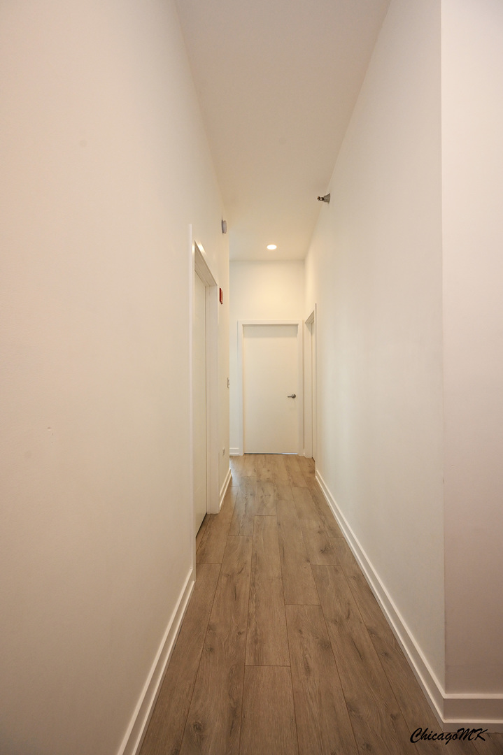235 West Van Buren Street, Unit 2213 Chicago, IL 60607 - Photo 14 of 31 a view of a room with wooden floor and white walls