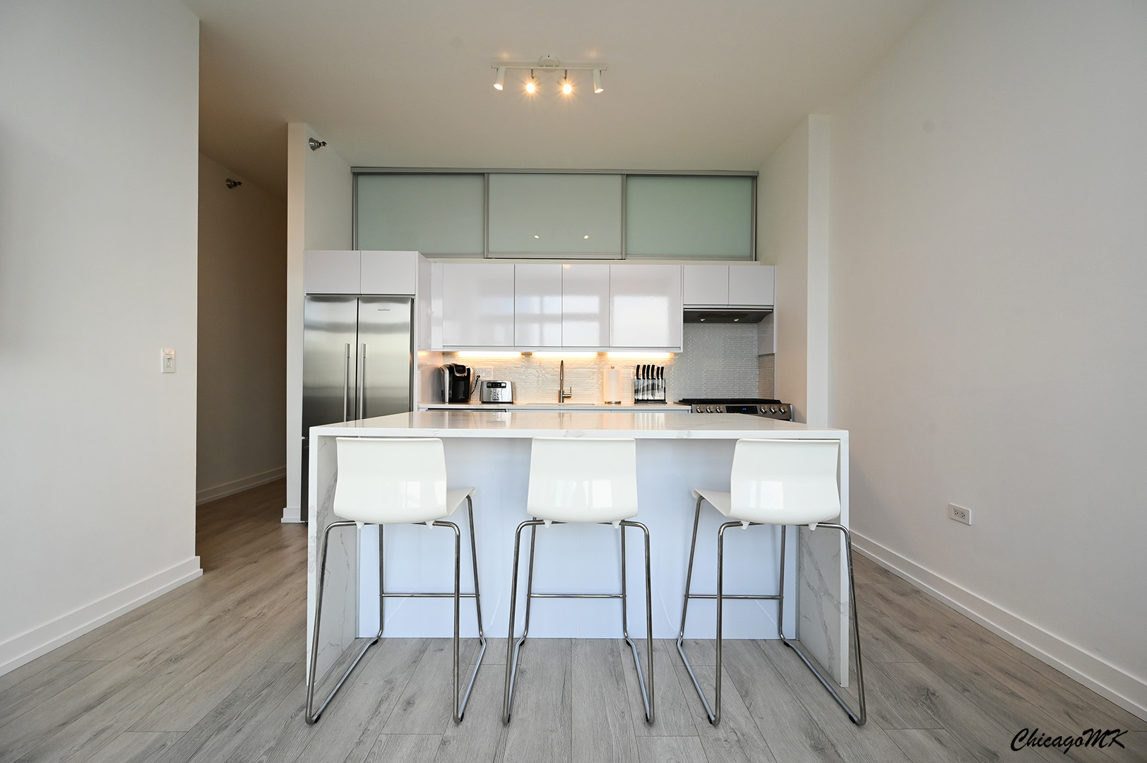 235 West Van Buren Street, Unit 2213 Chicago, IL 60607 - Photo 8 of 31 a kitchen with a sink cabinets and wooden floor