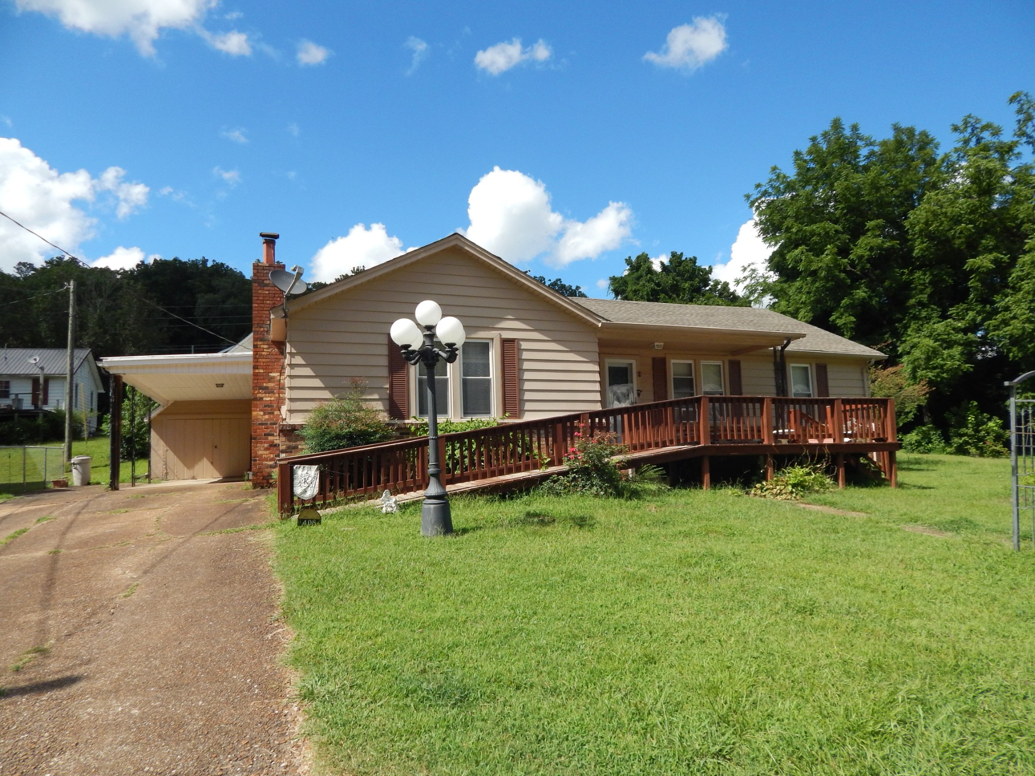 a view of a house with yard and sitting area