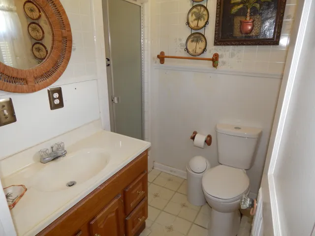 a bathroom with a sink mirror vanity and toilet