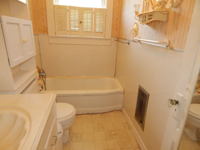 a bathroom with a tub and shower