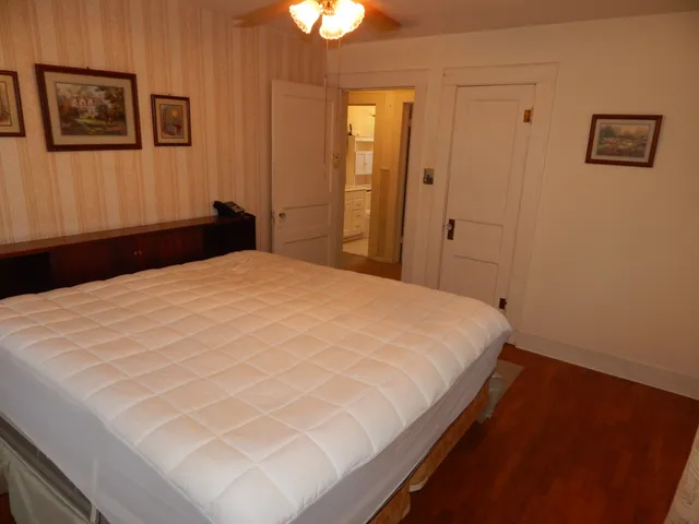 a large bed in a bedroom next to a lamp