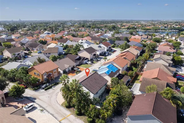 an aerial view of residential houses with outdoor space