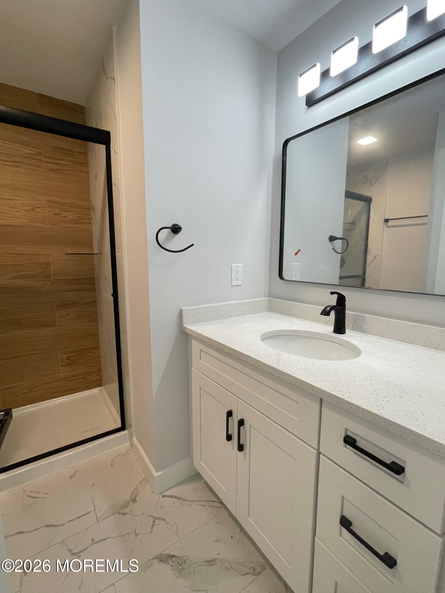 14 Churchill Road, Unit 71 Whiting, NJ 08759 - Photo 12 of 18 a bathroom with a sink a mirror and shower