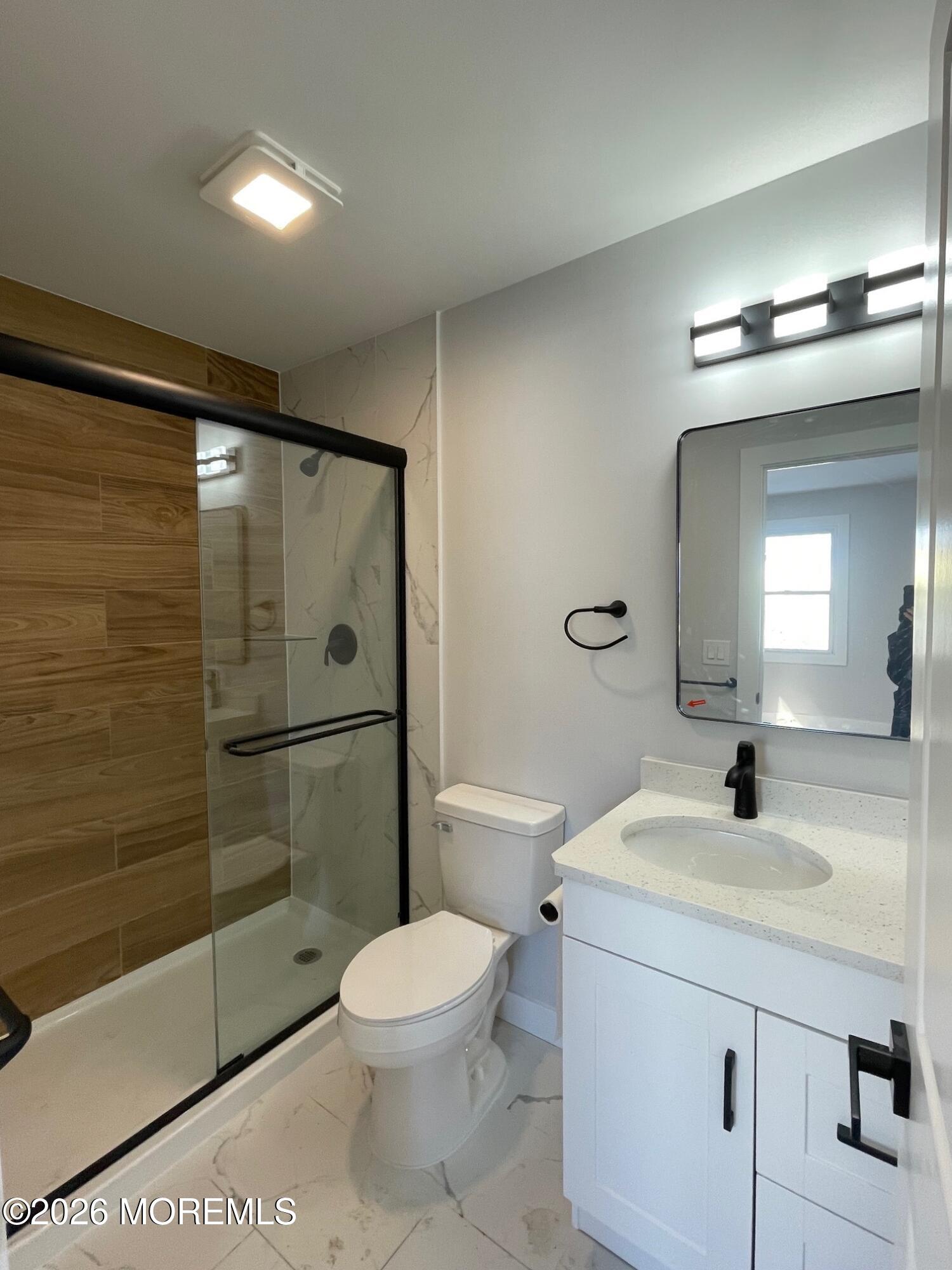 14 Churchill Road, Unit 71 Whiting, NJ 08759 - Photo 14 of 18 a bathroom with a toilet a sink and shower