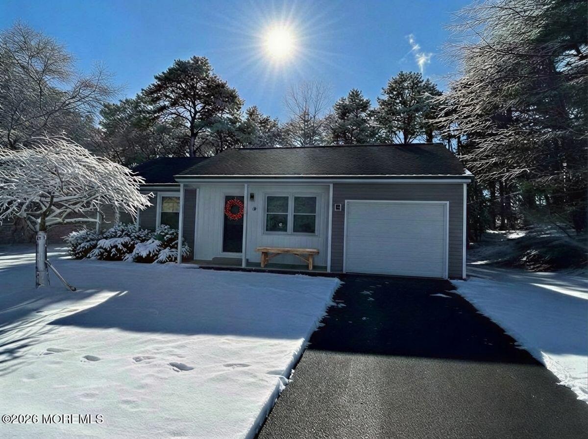 14 Churchill Road, Unit 71 Whiting, NJ 08759 - Photo 2 of 18 a front view of a house with a yard and garage