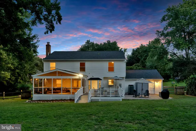 a view of a house with a yard porch and sitting area