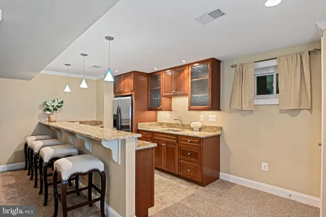 a view of bathroom with sink mirror and toilet