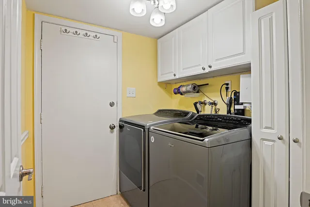 a view of a house with wooden deck and furniture