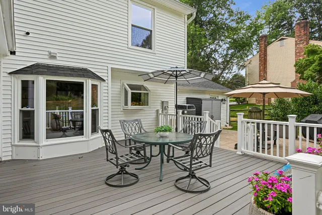 a view of a wooden deck and backyard