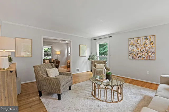 a living room with furniture a rug and a table