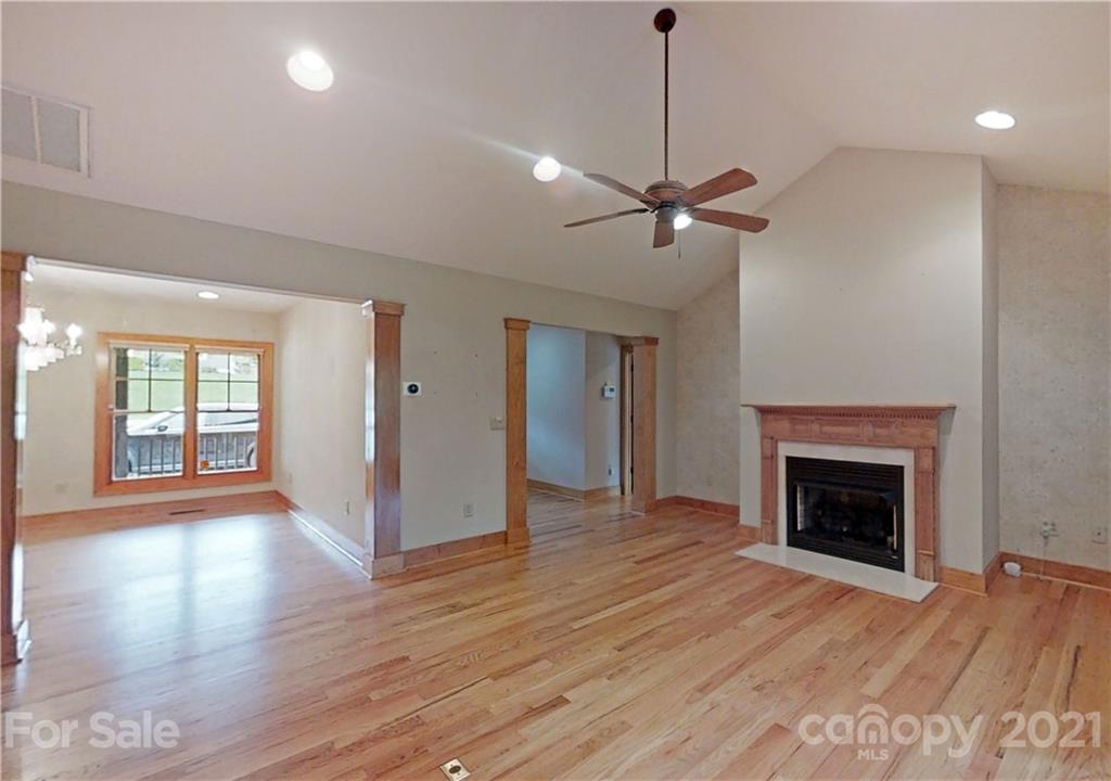 56 Devonshire Drive Mills River, NC 28759 - Photo 3 of 43 a view of an empty room with wooden floor fireplace and a window