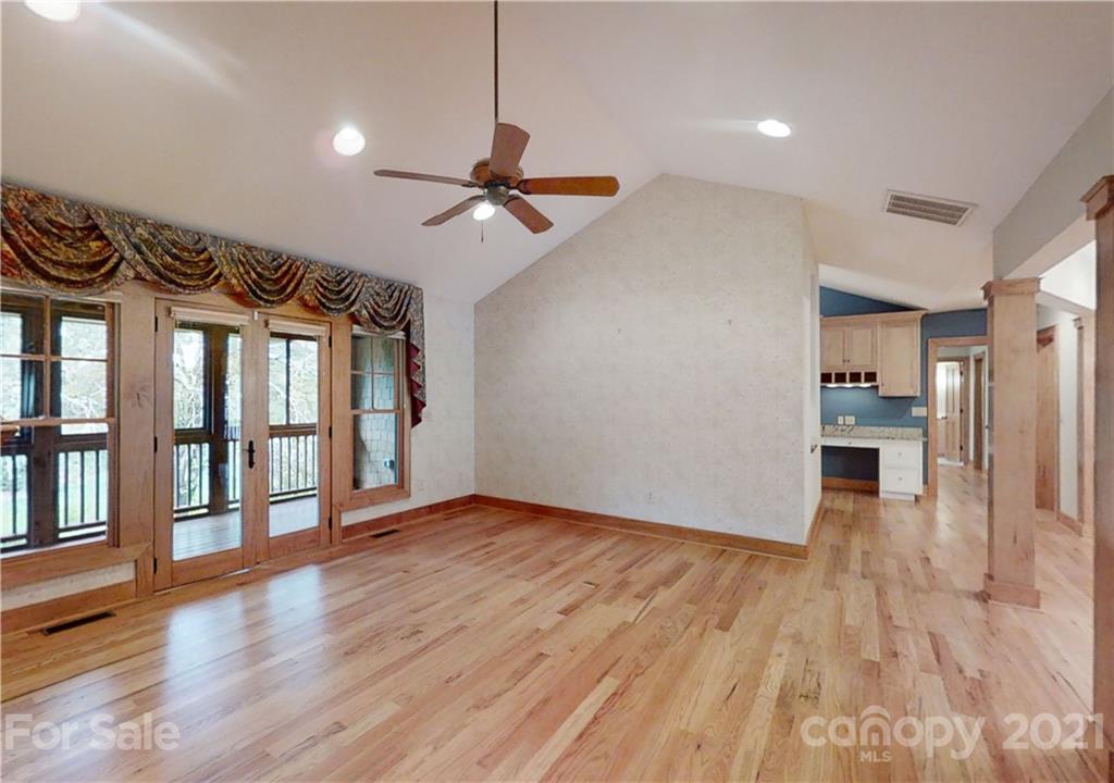 56 Devonshire Drive Mills River, NC 28759 - Photo 4 of 43 a view of a livingroom with wooden floor a ceiling fan and windows