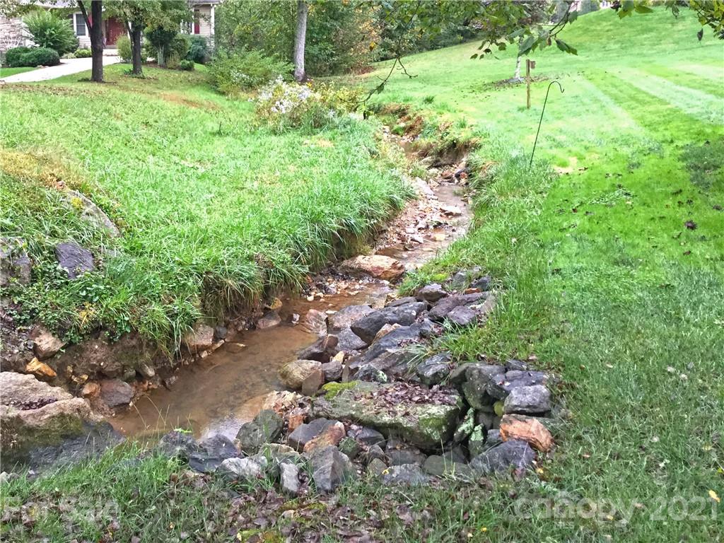 56 Devonshire Drive Mills River, NC 28759 - Photo 40 of 43 a backyard of a house with a yard and outdoor seating