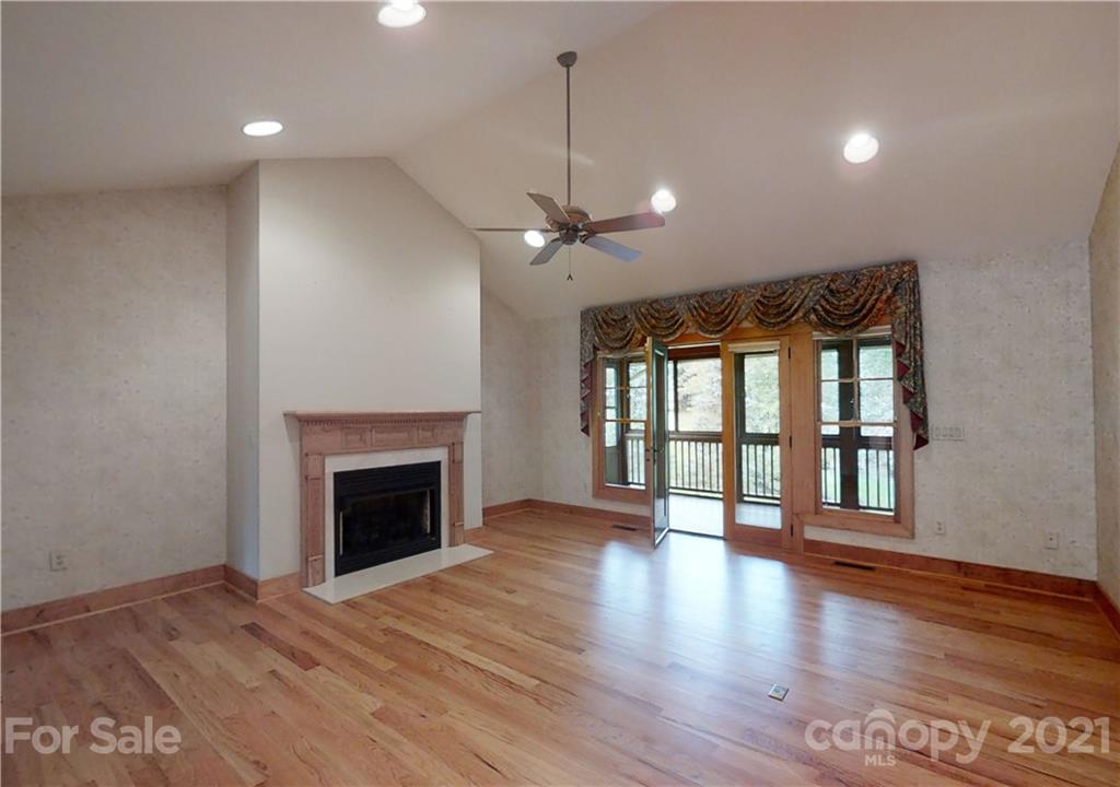 56 Devonshire Drive Mills River, NC 28759 - Photo 5 of 43 a view of an empty room with wooden floor fireplace and a window