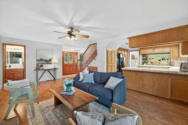 a spacious bedroom with a large bed and a chandelier