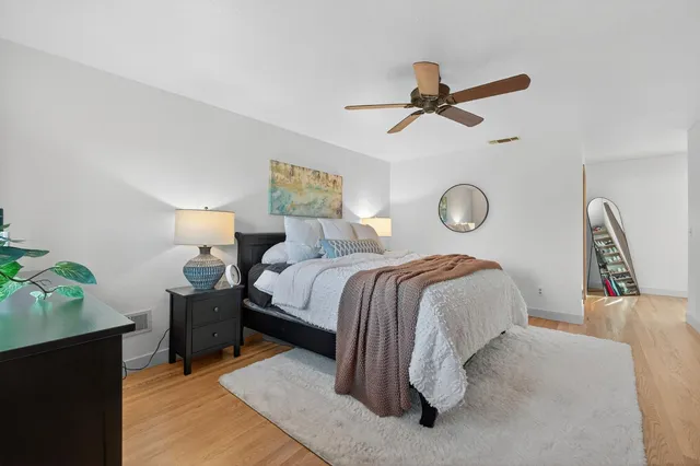 a view of a backyard with table and chairs with wooden floor and fence