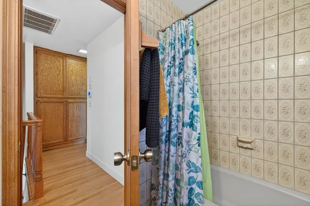 a living room with furniture a chandelier and a dining room