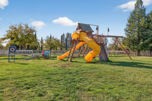 an empty room with a ceiling fan and a window
