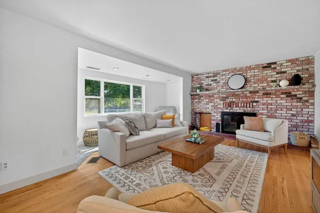 a living room with furniture a rug and a flat screen tv