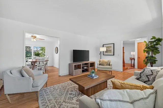 a living room with furniture and wooden floor