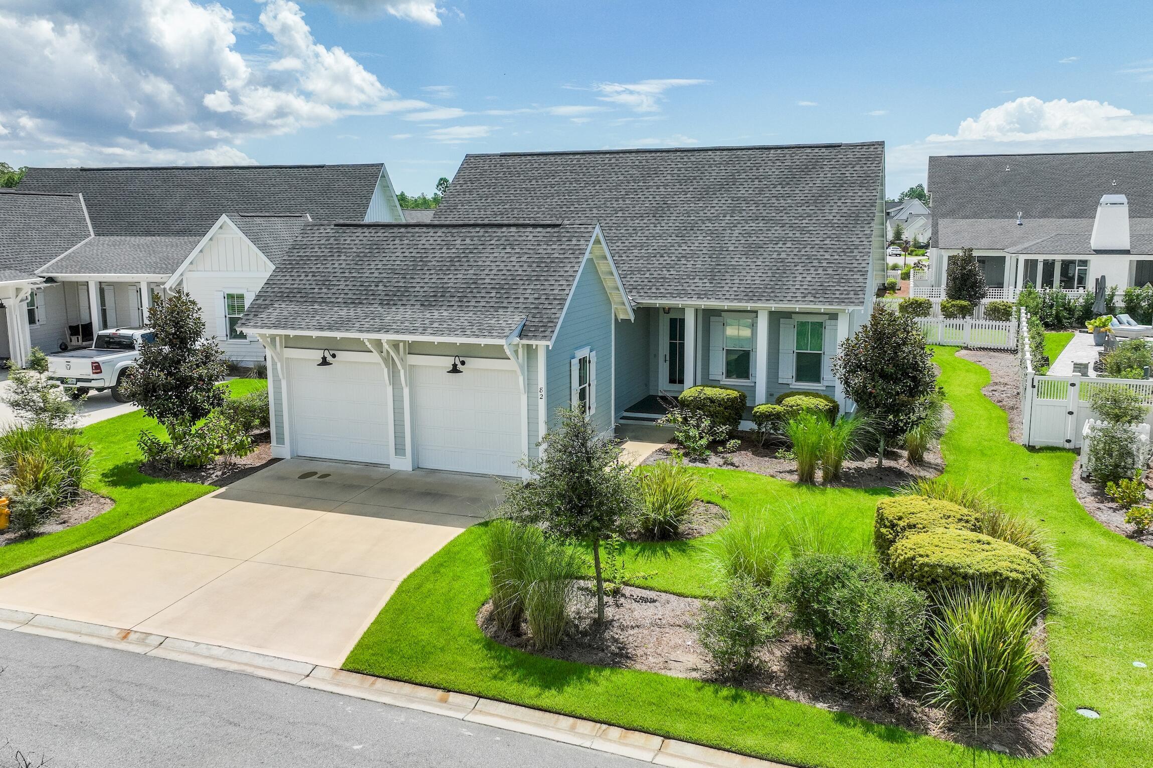 a aerial view of a house with a yard and potted plants