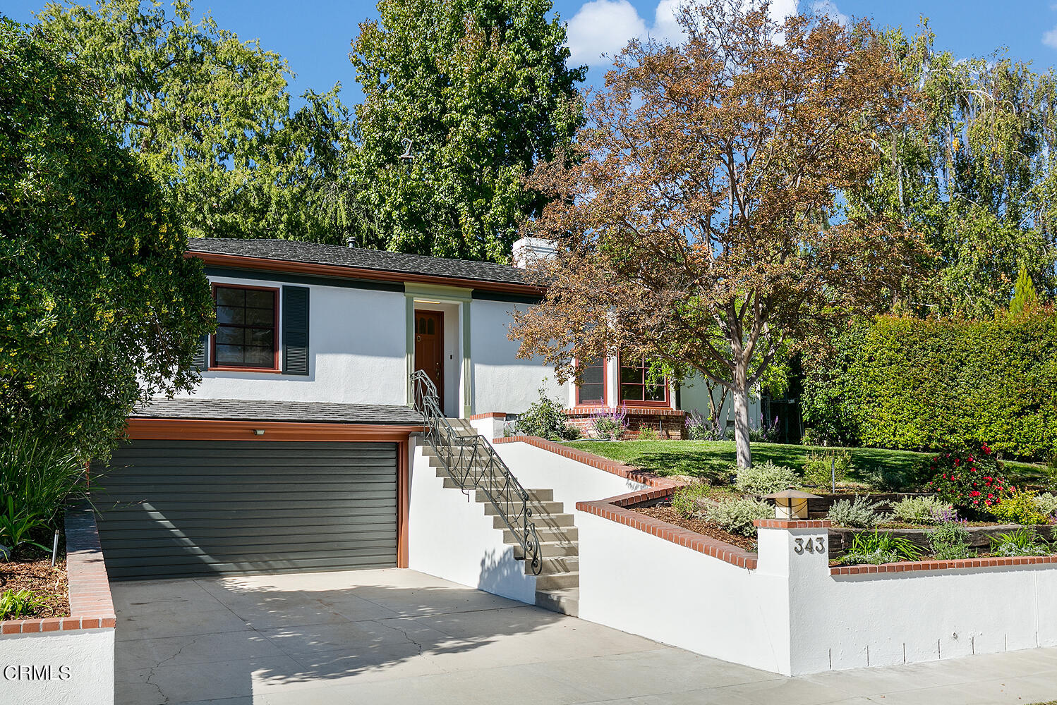 a front view of a house with garden