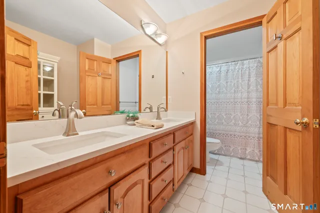 a bathroom with a double vanity sink mirror and double