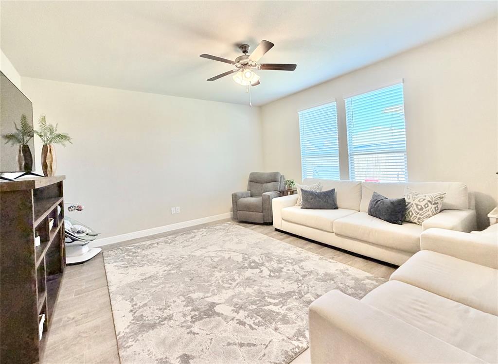 2429 Goodnight Ranch Drive Weatherford, TX 76087 - Photo 14 of 32 a living room with furniture and a chandelier