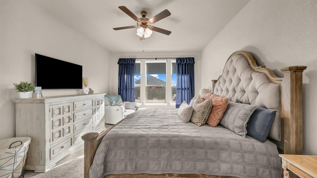 2429 Goodnight Ranch Drive Weatherford, TX 76087 - Photo 15 of 32 a bedroom with a bed and a flat screen tv