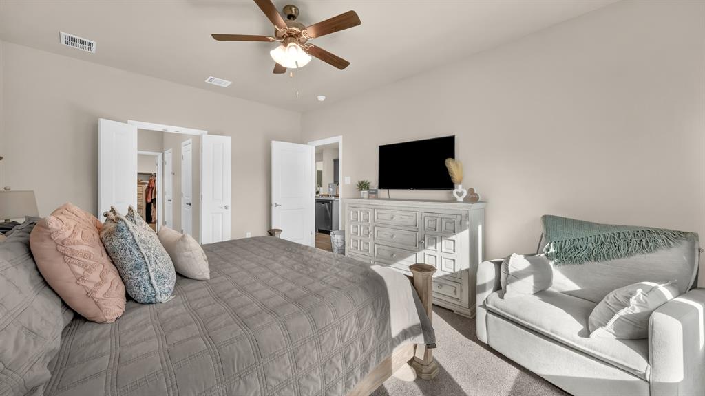 2429 Goodnight Ranch Drive Weatherford, TX 76087 - Photo 16 of 32 a bedroom with a bed and a flat screen tv