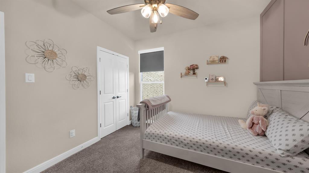 2429 Goodnight Ranch Drive Weatherford, TX 76087 - Photo 23 of 32 a bedroom with a bed and a chandelier
