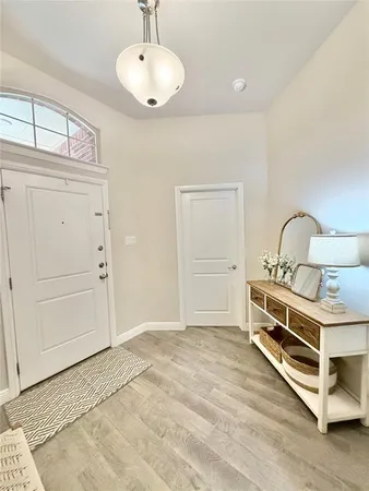 a kitchen with a table chairs refrigerator and cabinets